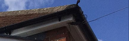 image of black guttering around the side of a house